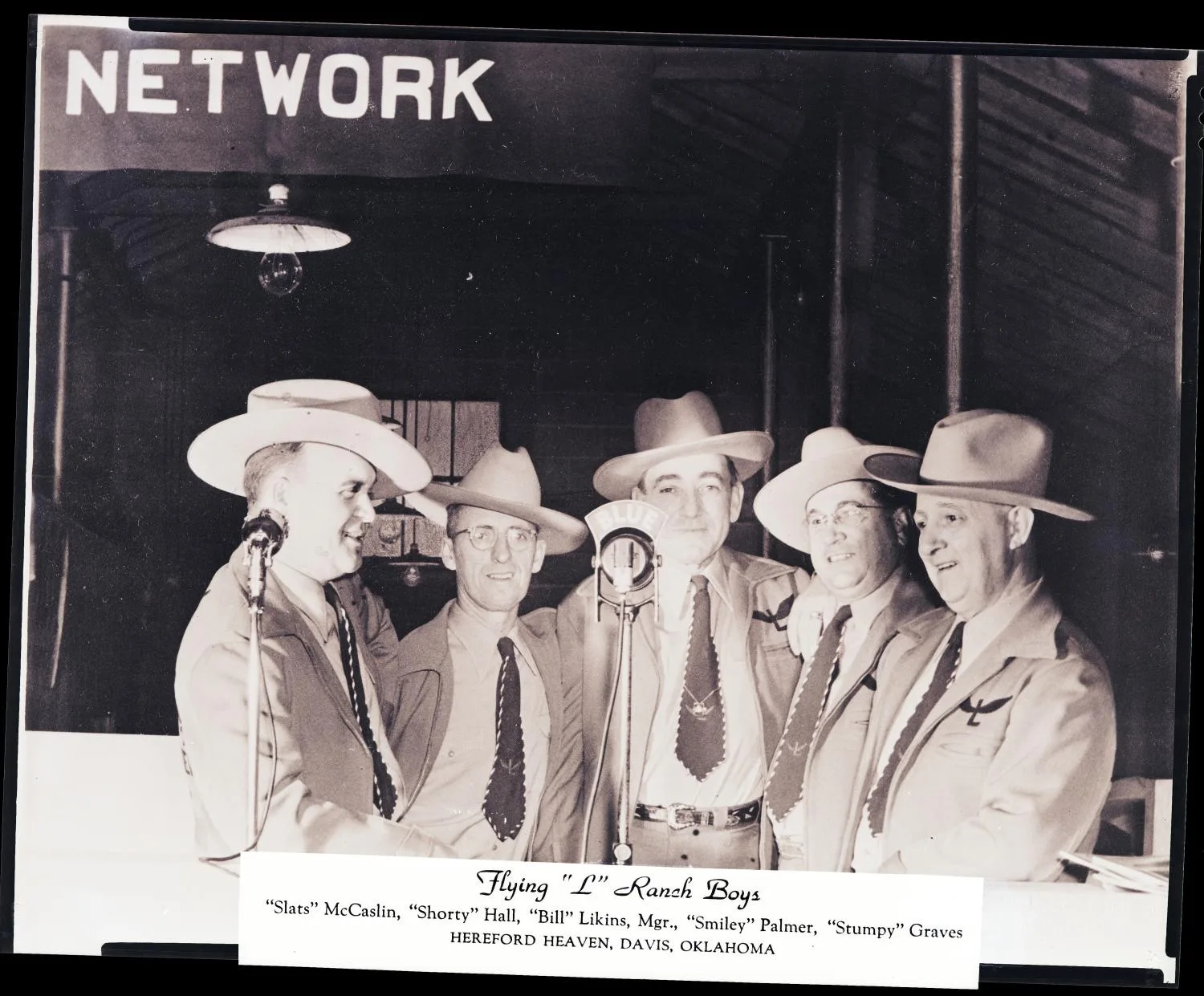 Photograph of The Flying "L" Ranch Boys band, Hereford Heaven, Davis, OK. Photo taken by Meyers Photo Shop for the Flying "L" Ranch Boys Acct.