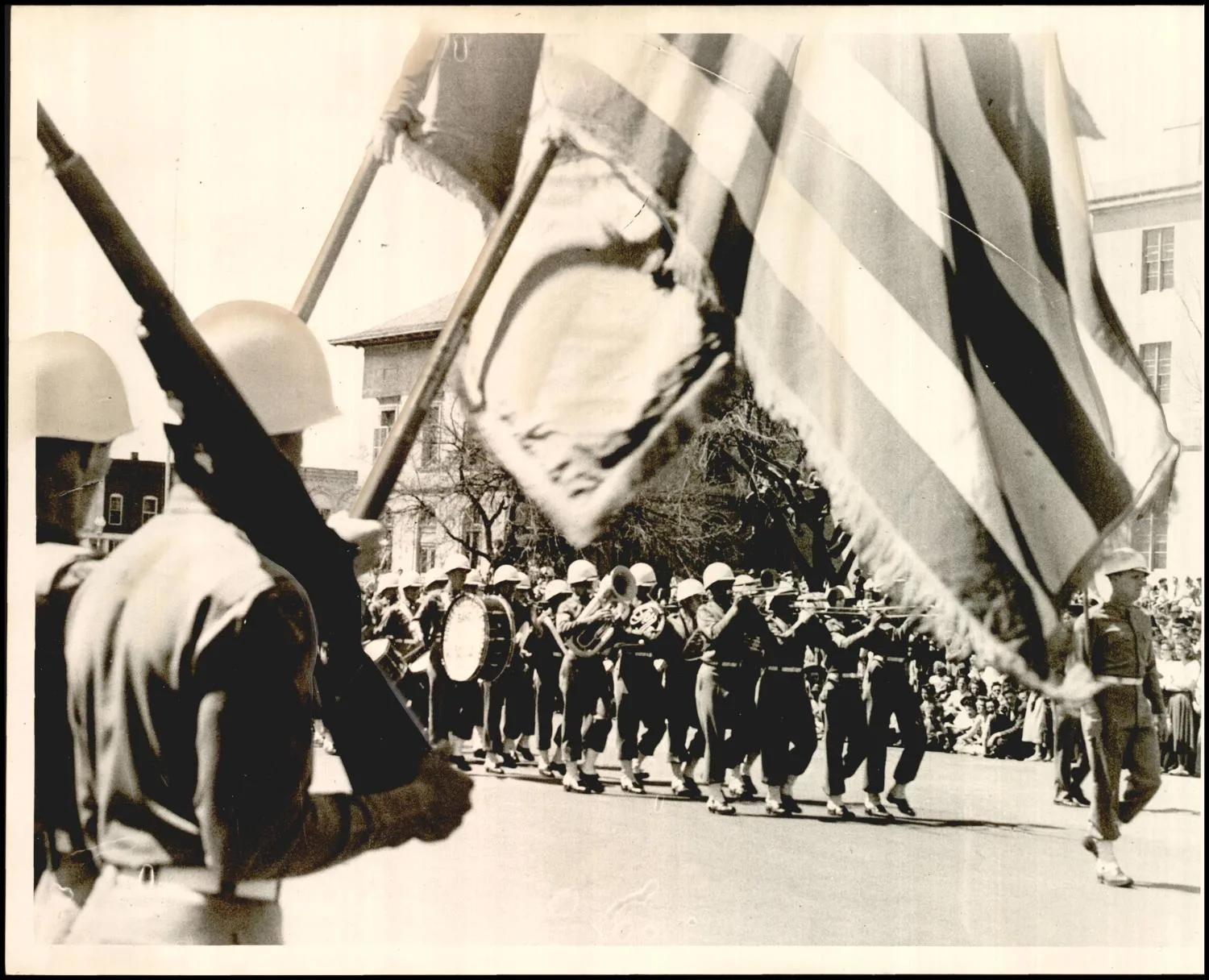 Photograph used for a story in the Daily Oklahoman newspaper. Caption: "Oklahoma Military academy pass the colors during the Tri-state band festival in enid"