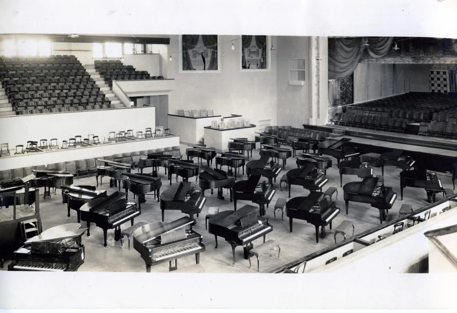 Photograph of people setting up a hall for a Piano Competition, Enid, OK. Photo by Cochrane, Enid, OK.