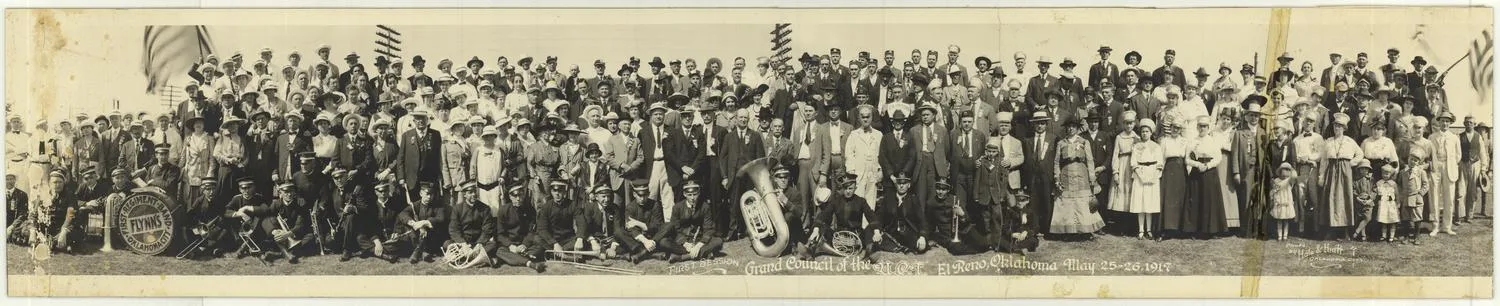 Group photo of a large amount of people in rows from the ground and up. A band sitting on the ground. Title: "First Session. Grand Council of the U.C.T. El Reno, Oklahoma. May 25-26, 1917."