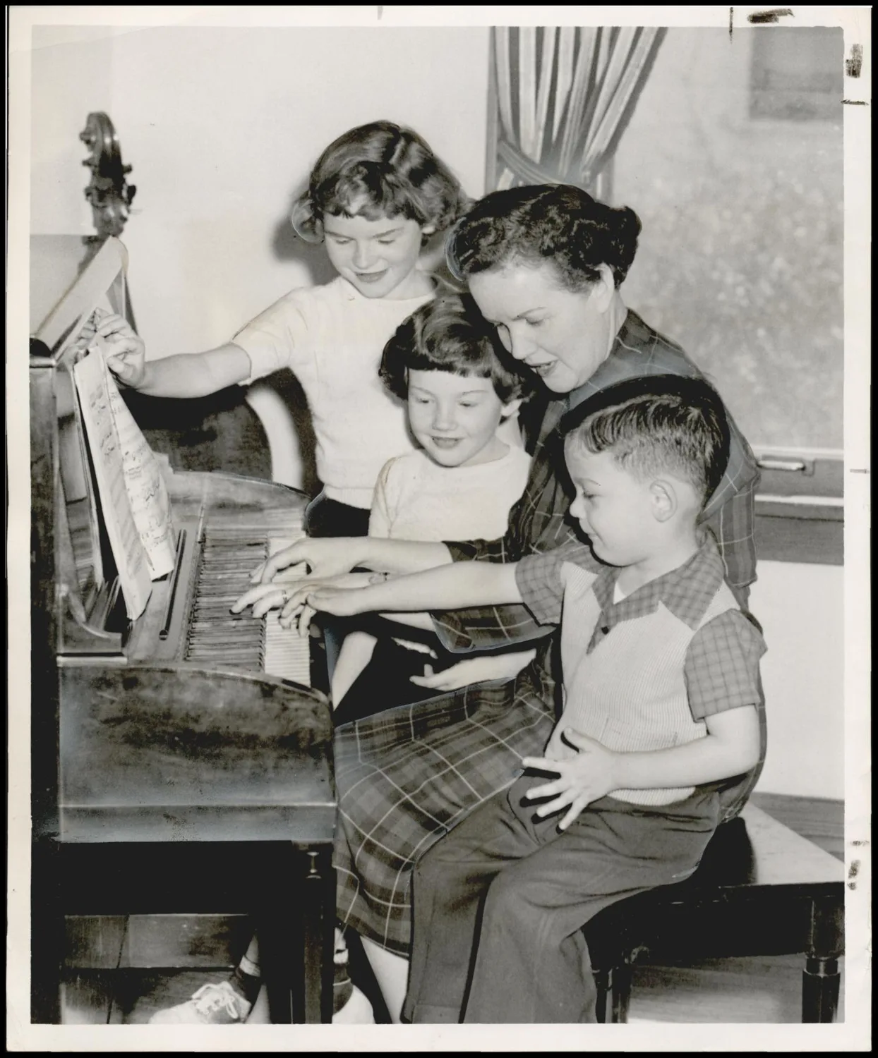 Photograph taken for a story in the Oklahoma Times newspaper. Caption: "Mom, We'll Help You With the Piano"