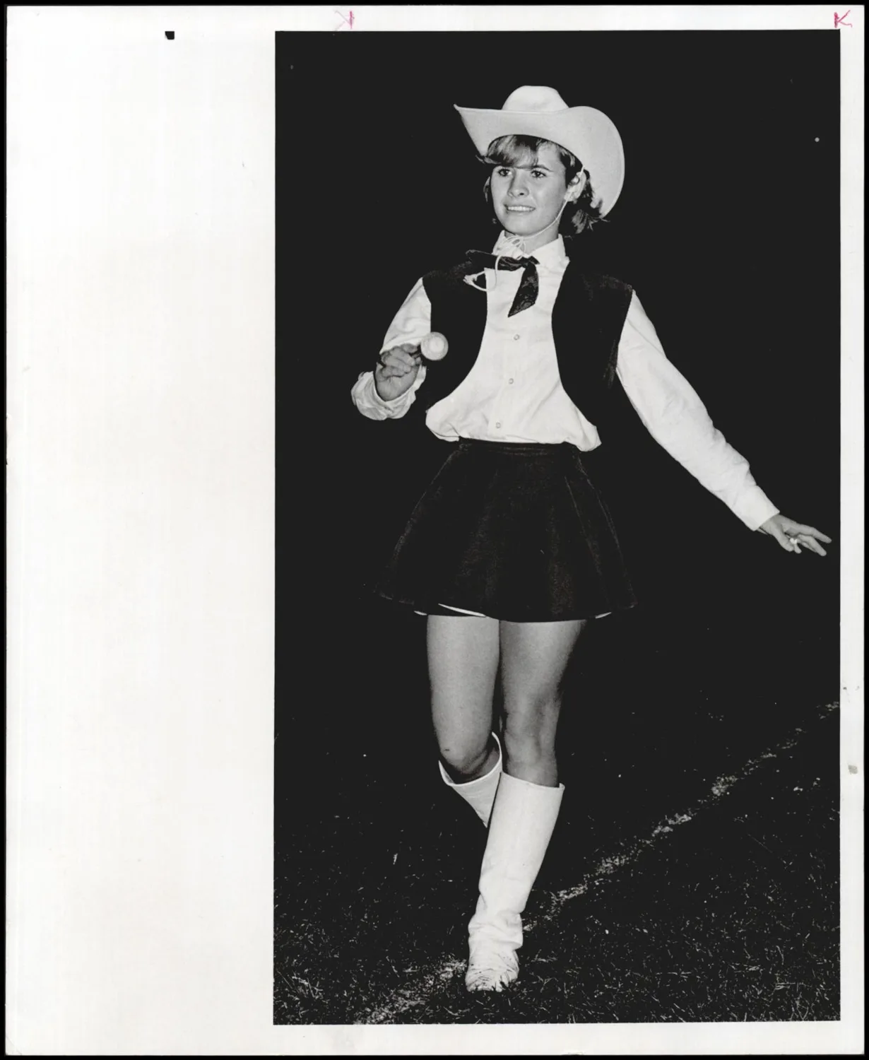 Photograph used for a story in the Daily Oklahoman newspaper. Caption: "Marlow twirler Debbie Strover, a junior, steps lively to the band beat at halftime."