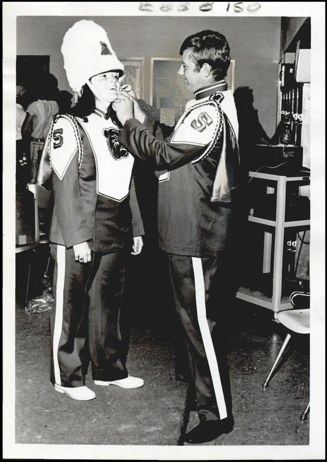 Photograph used for a story in the Oklahoma Times newspaper. Caption: "Getting suited up in their new band uniforms are students Frances Smudrick, El Reno, and Dennis Longdale."