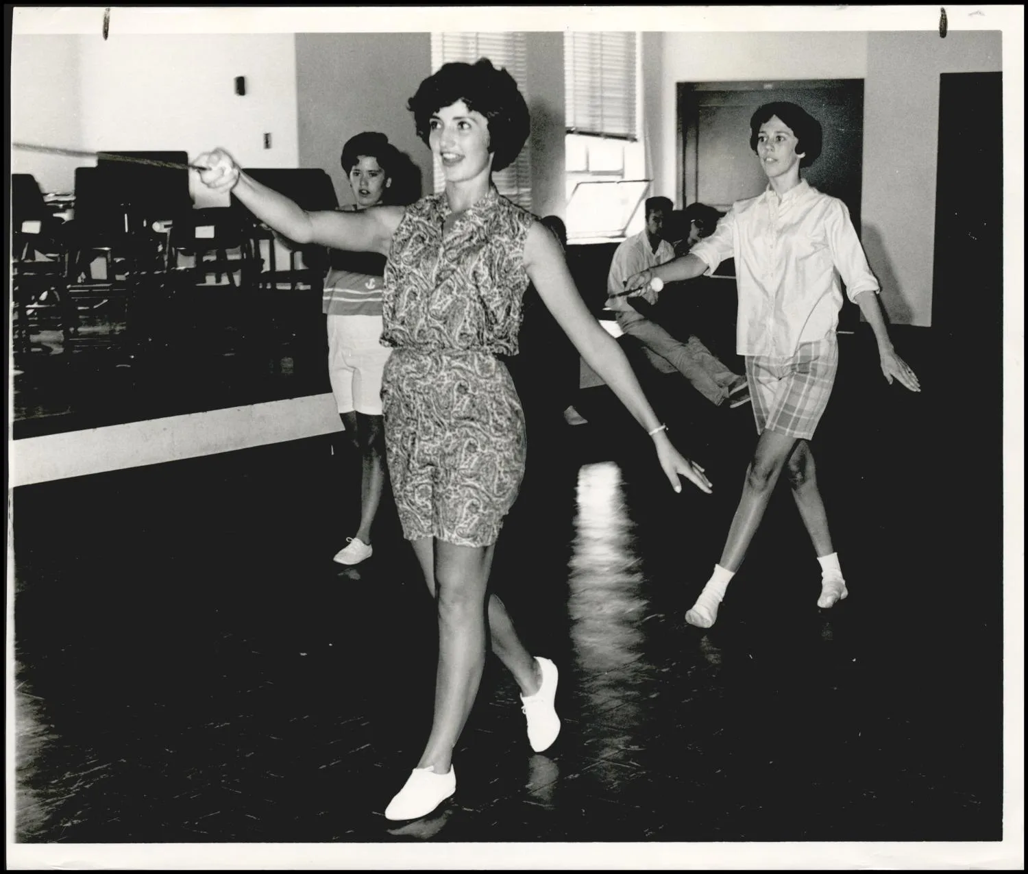 Photograph used for a story in the Oklahoma Times newspaper. Caption: "Twirlers with the ranger band at Norwester State college, Alva, spent an afternoon working out under the guidance of Joyce Rice, foreground, Janie Wilson, and Linda Nichols."