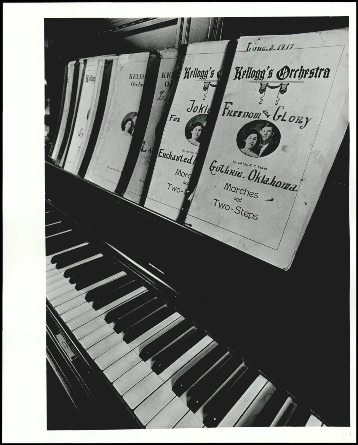 Photograph used for a newspaper owned by the Oklahoma Publishing Company. Caption: "Verna Kellogg West Afew of many orchestra arrangements used by the Kellogg Orchestra during silent movie days. Mrs. West and her first husband, N.P. Kellogg are pictured on the front."