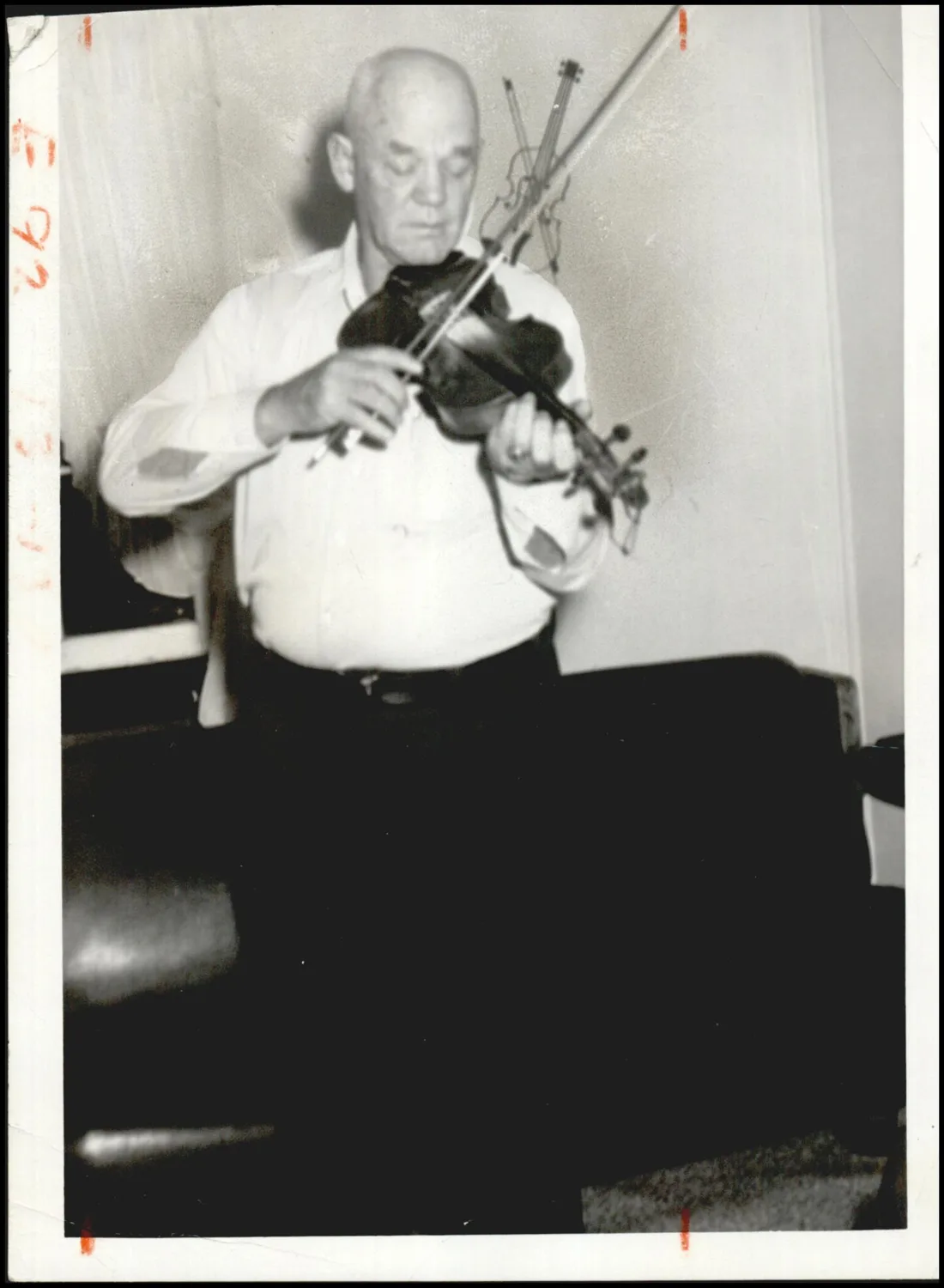 Photograph used for a story in the Daily Oklahoman newspaper. Caption: "Lawrence Wolfe never had a music lesson in his life but he and his fiddle have been audience pleasers around these parts for years."