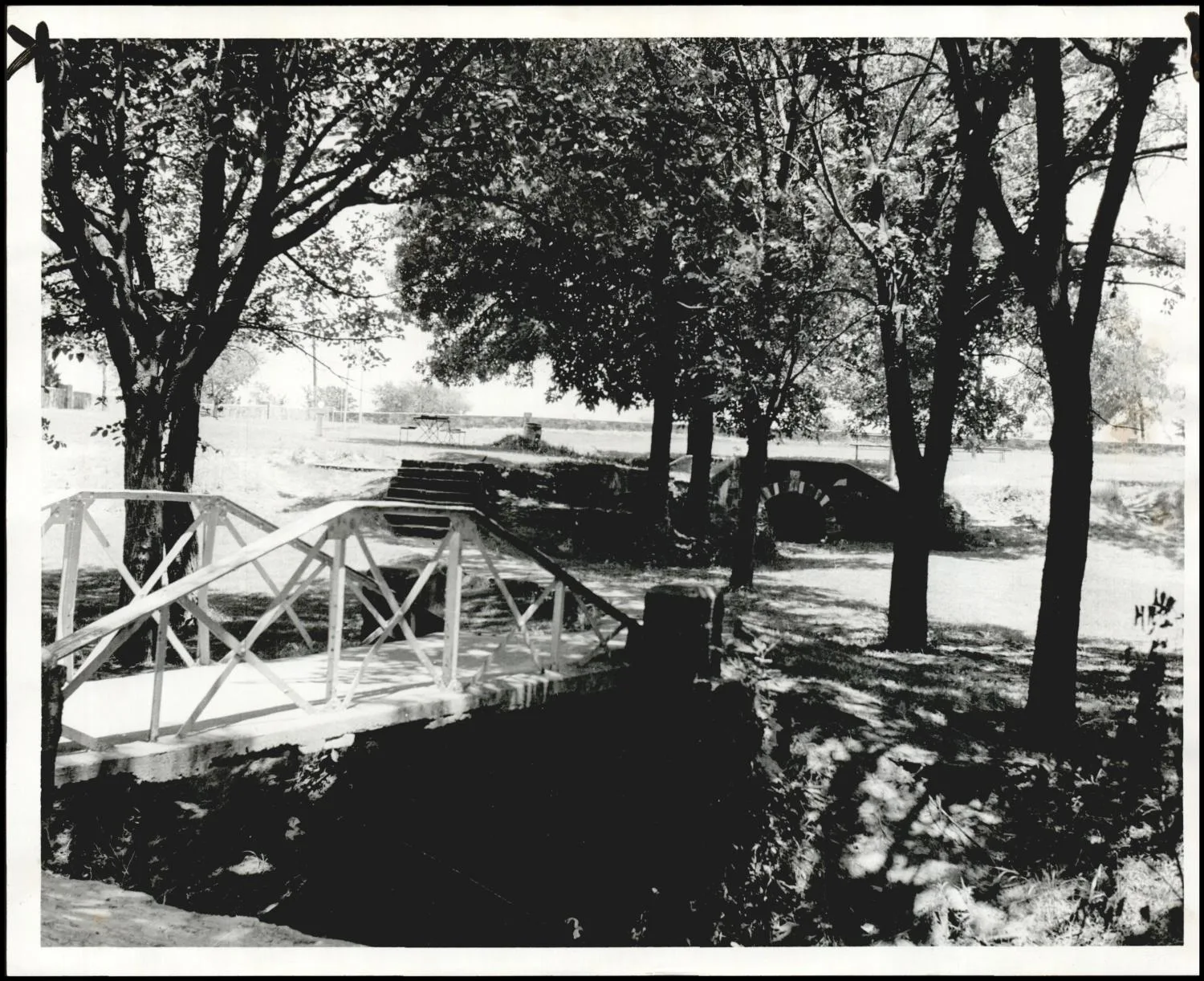 Photograph used for a story in the Daily Oklahoman newspaper. Caption: "Shaded picnic grounds are a popular attraction in Wewoka's East Side Park, which also features nine-hole golf course, shelter house, band shell and swimming pool."