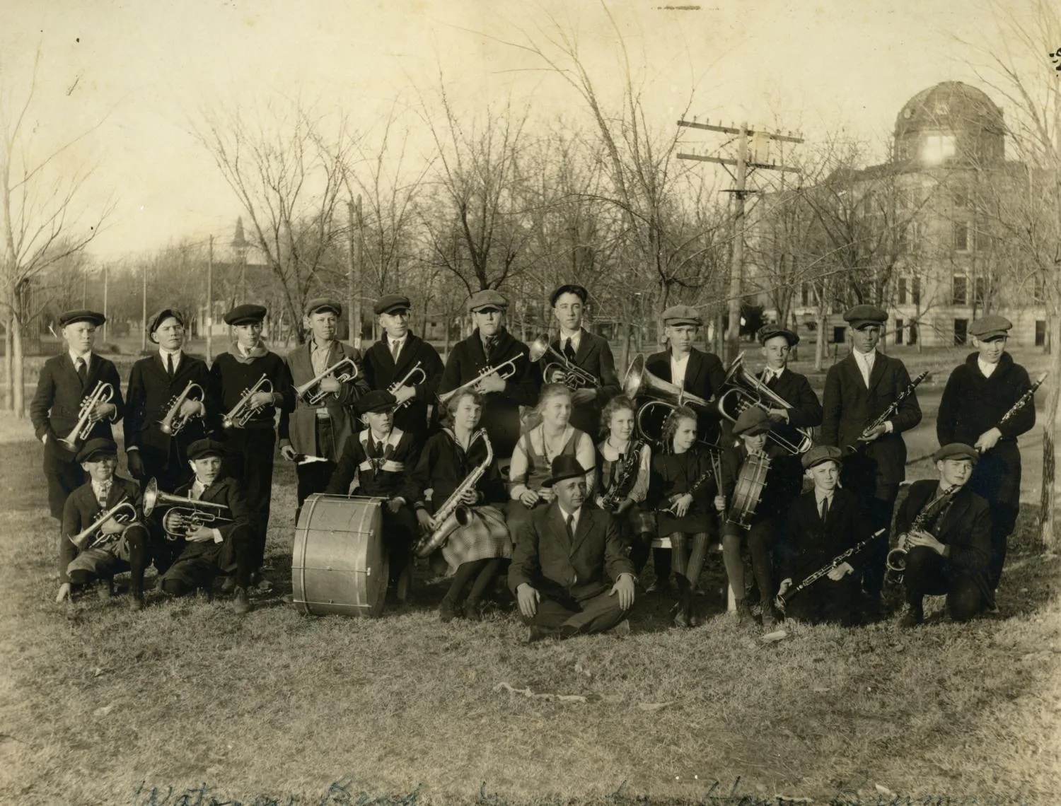 group of people posing with band gear in a field